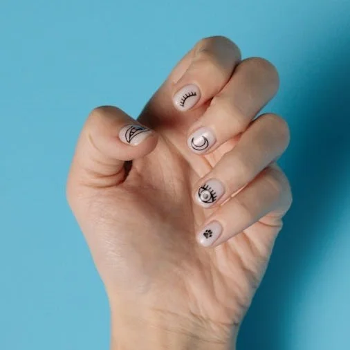 Short natural finger nails with quirky nail art