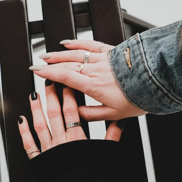 Hands of two different people with opposing style of nail